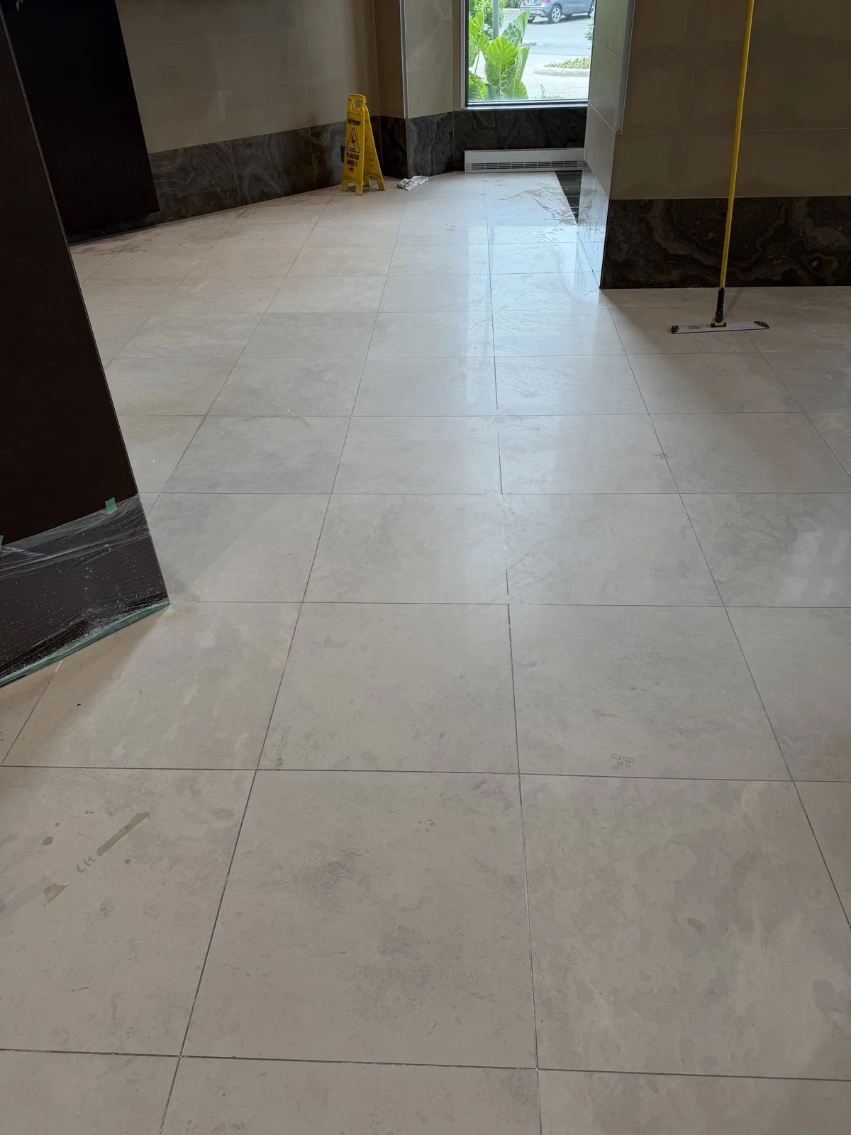 Marble lobby floor refinishing in progress on Nuns' Island