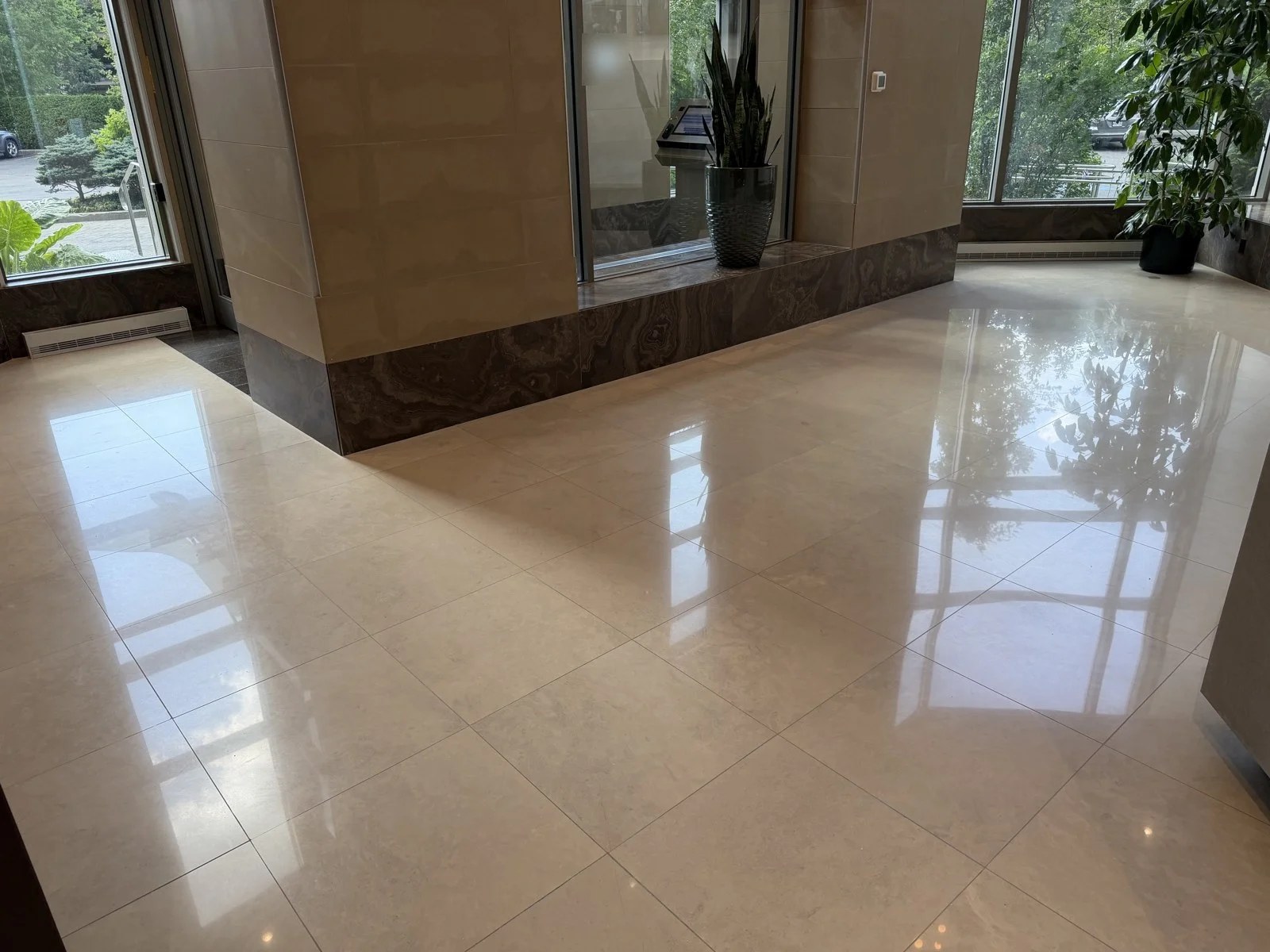 Marble lobby floor polished to a mirror finish on Nuns' Island, privacy-edited
