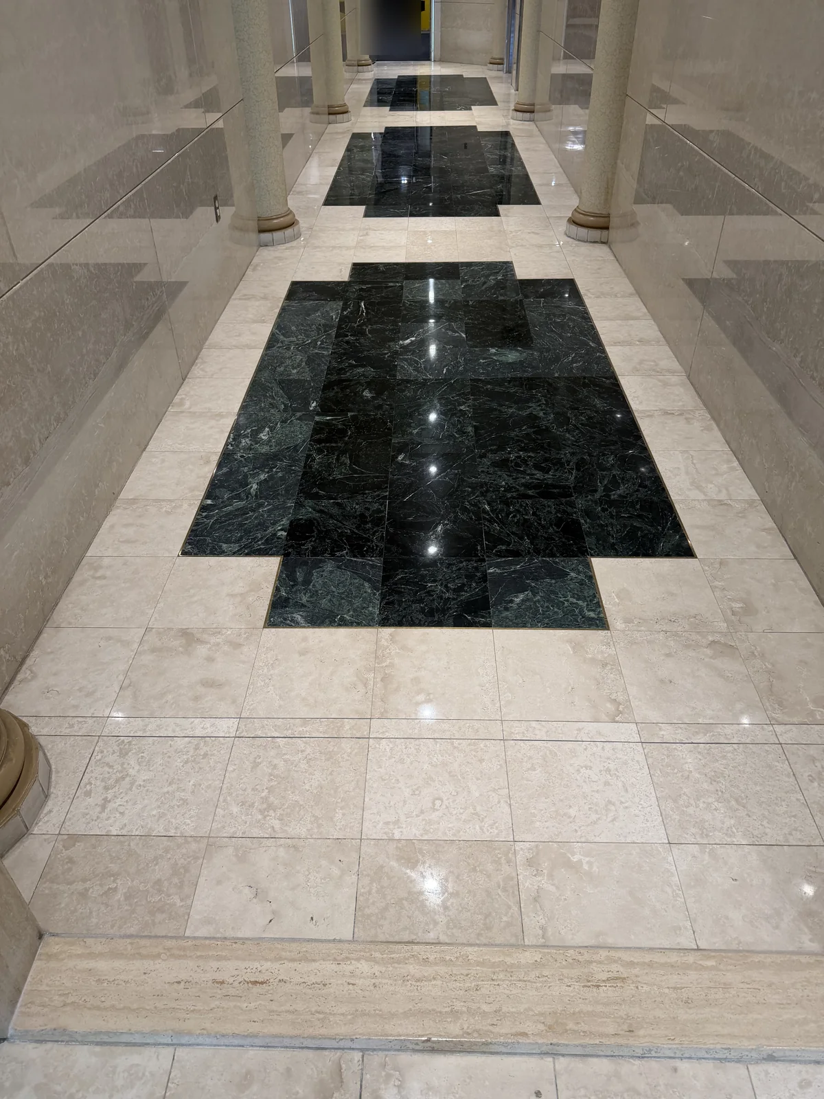 Polished marble corridor with a green marble band after restoration in Pierrefonds, privacy-edited