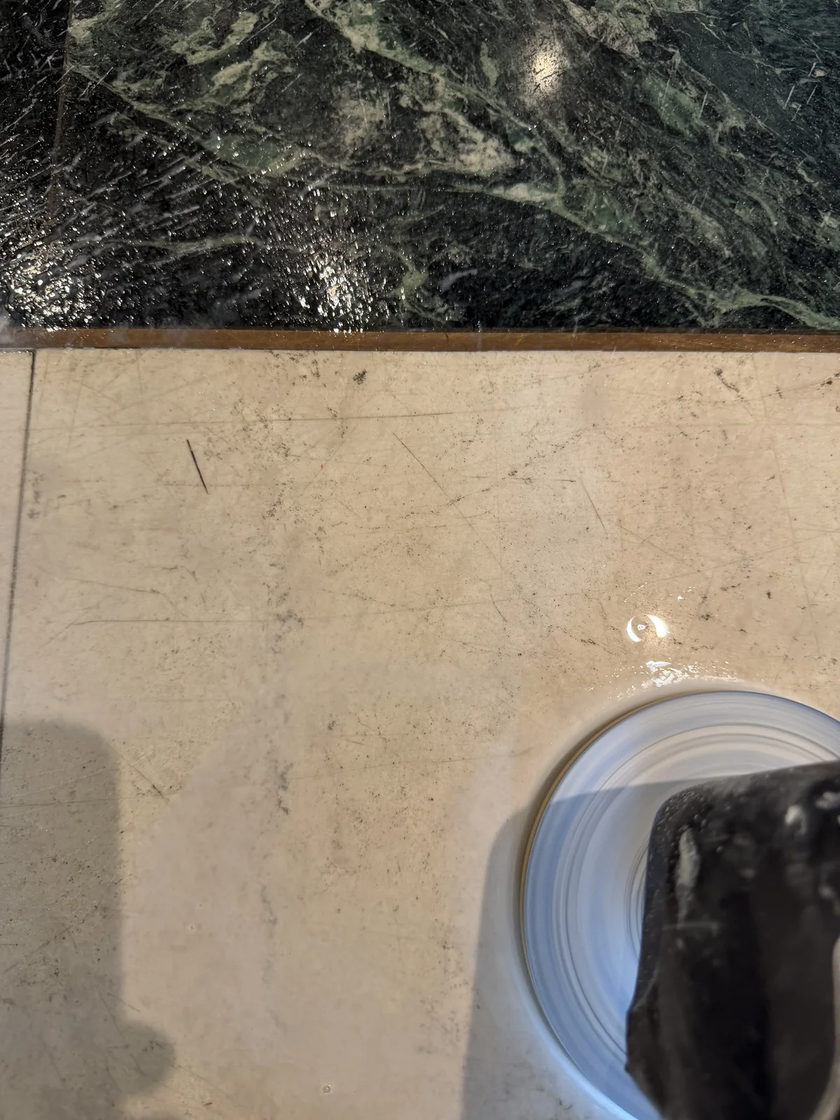 Polishing machine on a scratched marble tile during floor restoration in Pierrefonds