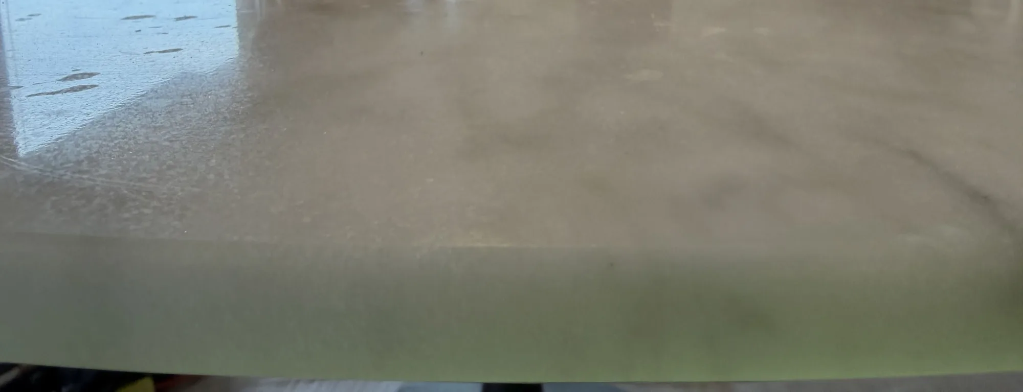 Close-up of surface damage on a marble dining table before honing