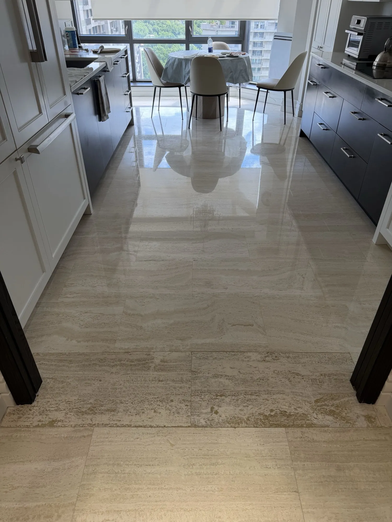 Travertine kitchen floor polished to a high-gloss finish in Outremont