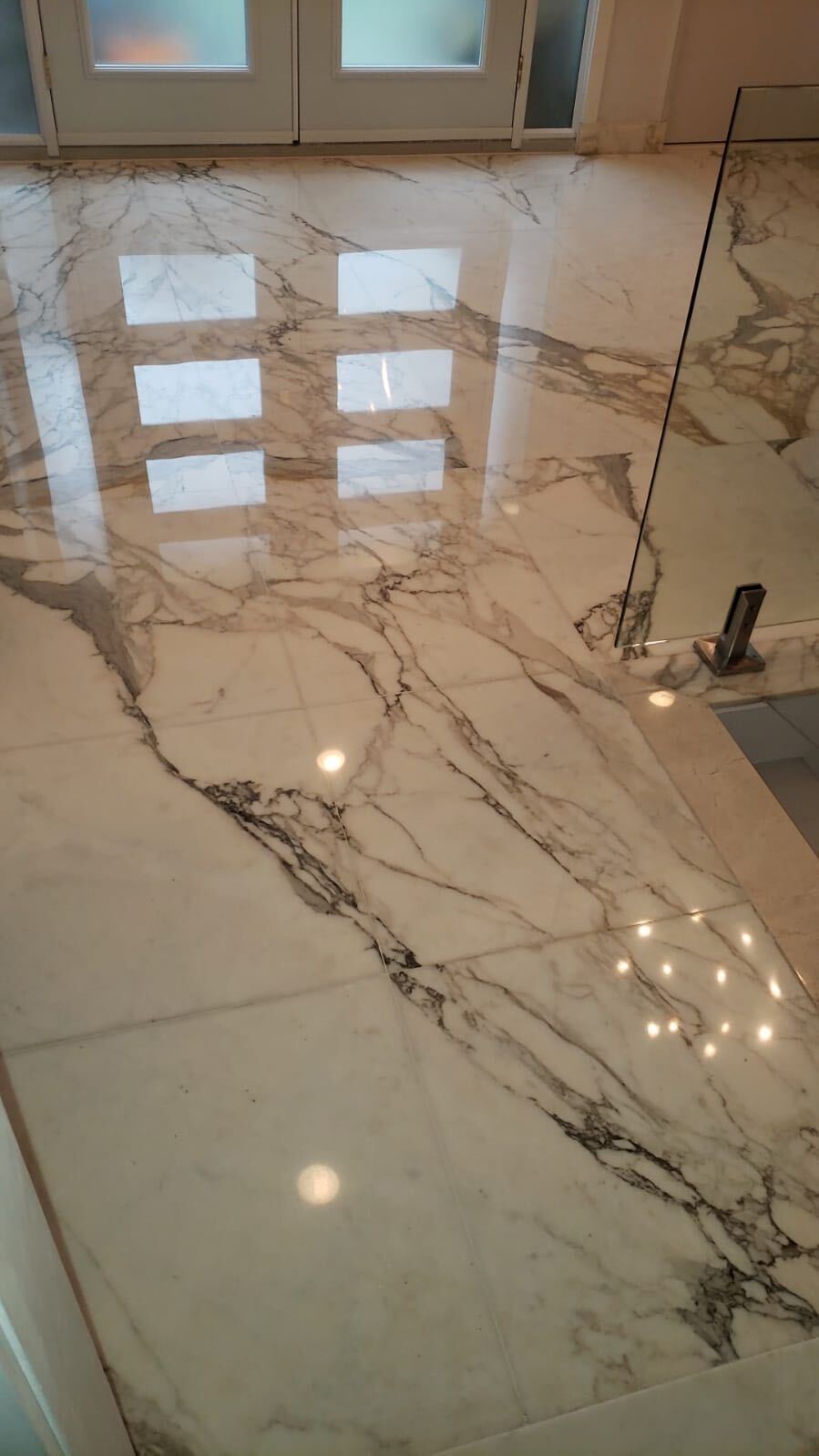 A marble bathroom floor restored to a high shine — High-shine finish after restoration