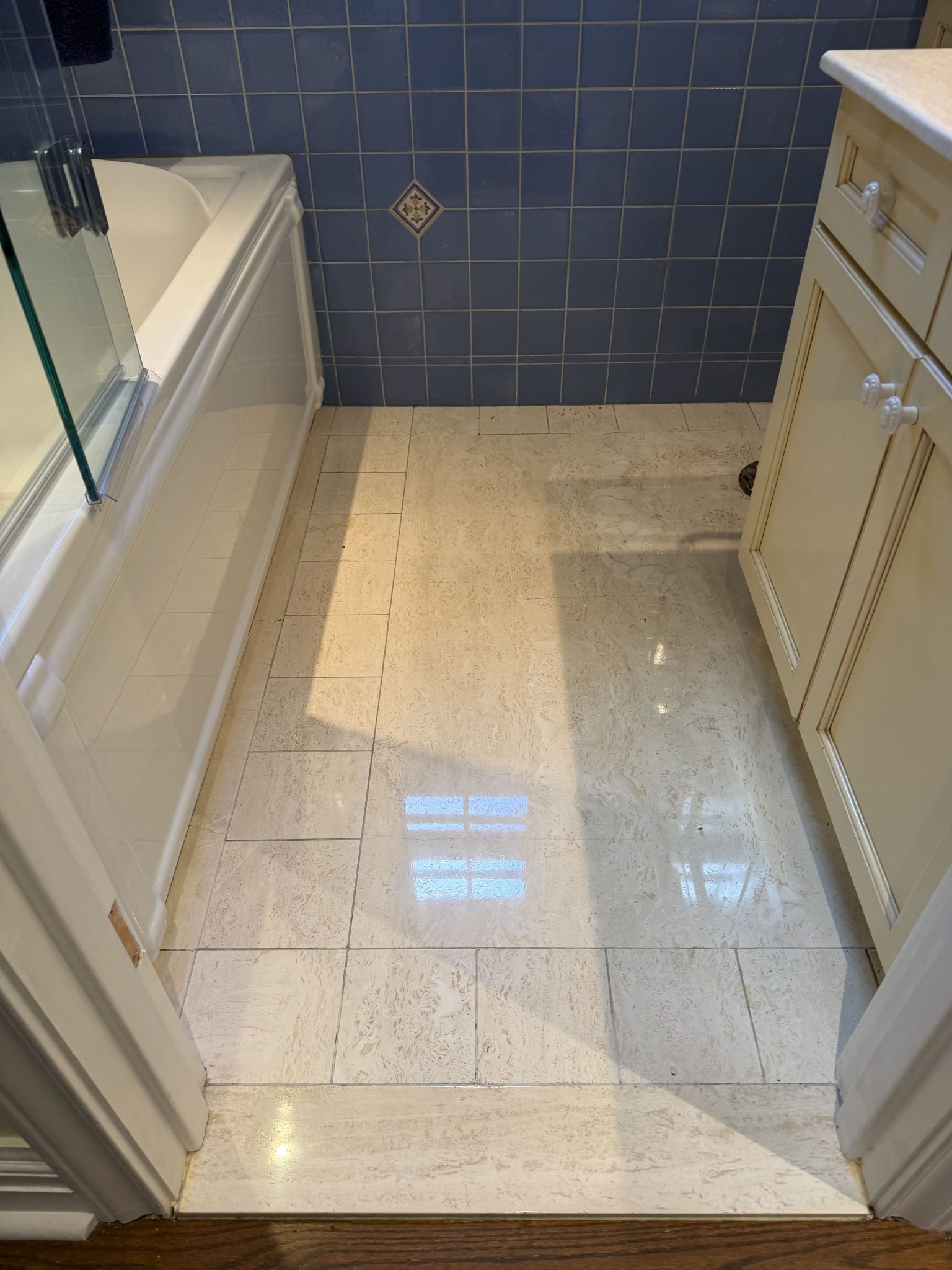 Restoring a travertine floor covered with glue residue — After restoration