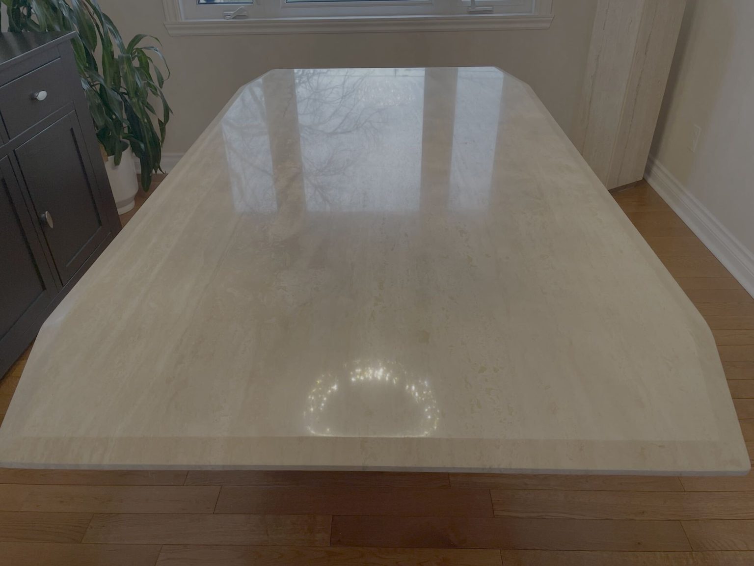 A travertine kitchen table restored in Dollard-des-Ormeaux — Restored and polished finish