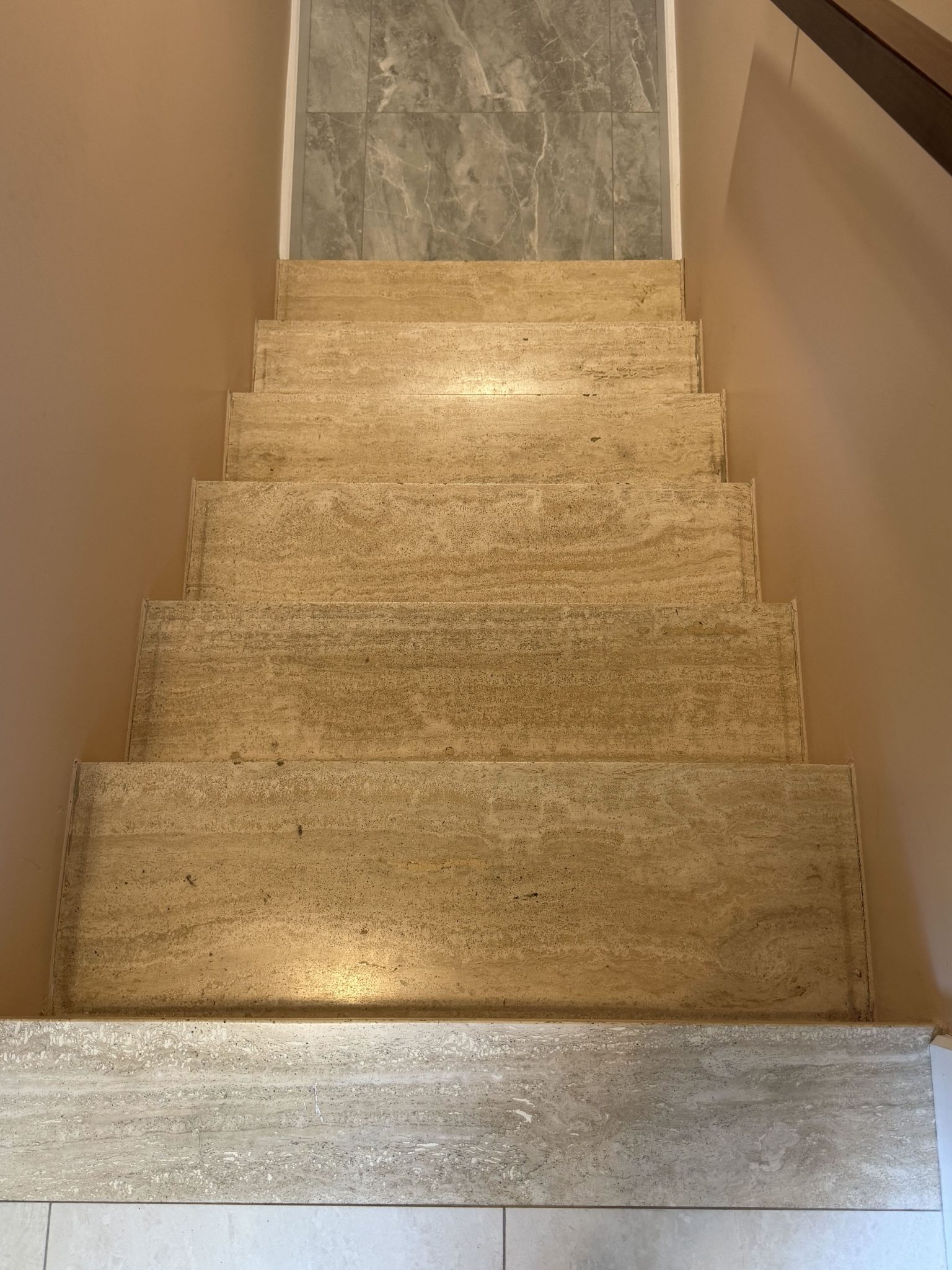 Travertine stairs restored to a high-gloss finish — Earlier surface condition